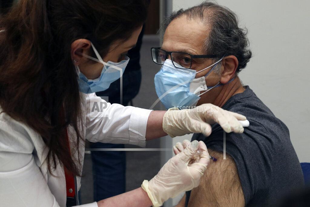 Bilal Hussein A healthcare worker receives Pfizer-BioNTech COVID-19 vaccine during a nationwide vaccination program at the American University Medical Center in Beirut, Lebanon, Sunday, Feb. 14, 2021. (AP Photo/Bilal Hussein)