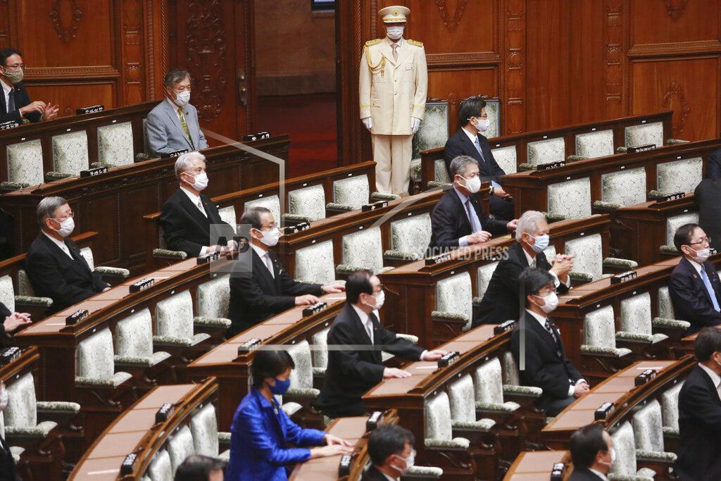 Koji Sasahara Japanese lawmakers wearing face masks to protect against the spread of the coronavirus attend an extraordinary Diet session at the upper house of parliament in Tokyo, Monday, Oct. 26, 2020. (AP Photo/Koji Sasahara)