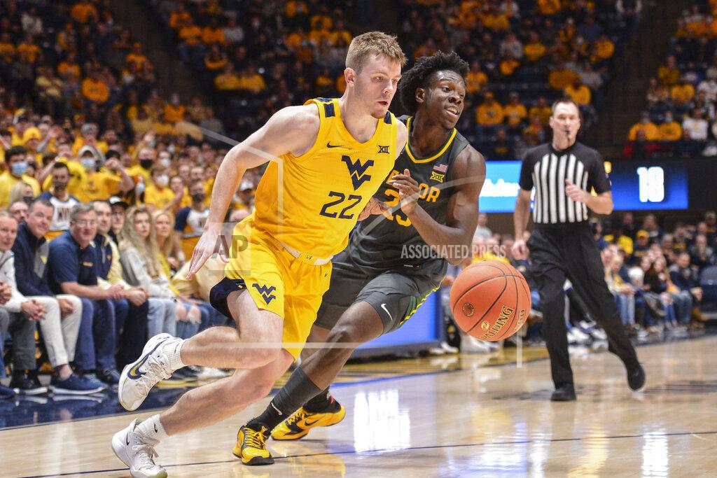 William Wotring West Virginia guard Sean McNeil (22) works the ball past Baylor forward Jonathan Tchamwa Tchatchoua (23) during the first half of an NCAA college basketball game in Morgantown, W.Va., Tuesday, Jan. 18, 2022. (William Wotring)