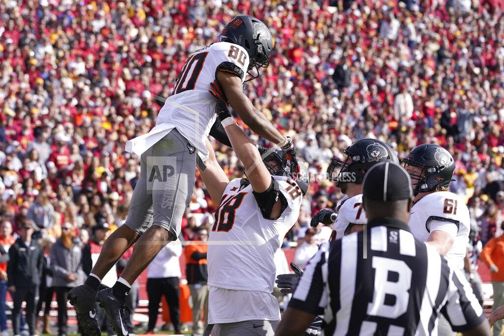 Charlie Neibergall Oklahoma State wide receiver Brennan Presley (80) celebrates with teammates after catching a 5-yard touchdown pass during the first half of an NCAA college football game against Iowa State, Saturday, Oct. 23, 2021, in Ames, Iowa. (AP Photo/Charlie Neibergall)