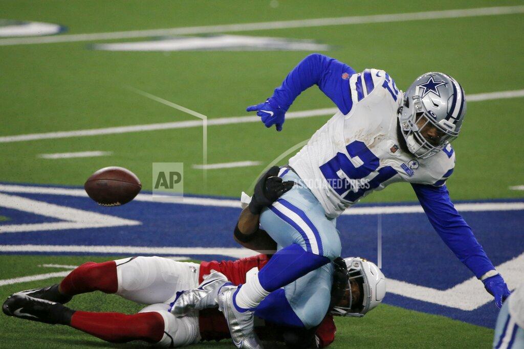 Michael Ainsworth Arizona Cardinals safety Budda Baker (32) strips the ball from Dallas Cowboys running back Ezekiel Elliott (21) in the first half of an NFL football game in Arlington, Texas, Monday, Oct. 19, 2020. (AP Photo/Michael Ainsworth)