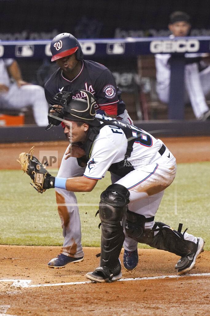 Marta Lavandier Washington Nationals' Alcides Escobar collides with Miami Marlins catcher Nick Fortes (84) during the sixth inning of a baseball game, Tuesday, Sept. 21, 2021, in Miami. Escobar scored on the play. (AP Photo/Marta Lavandier)
