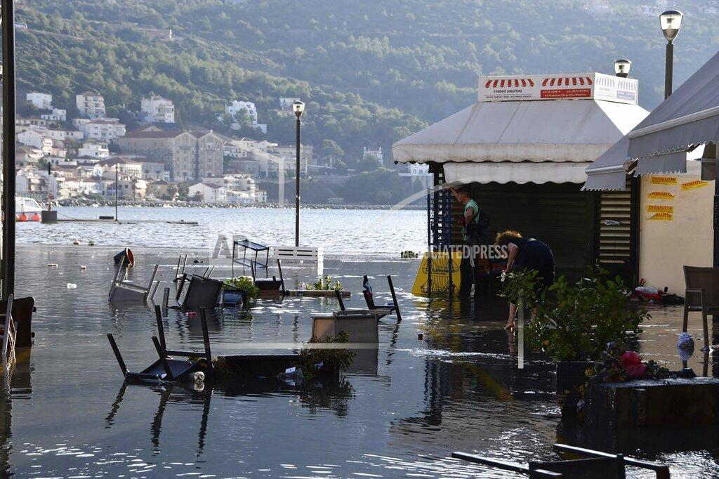 Michael Svarnias Seawater covers a square after an earthquake at the port of Vathi on the eastern Aegean island of Samos, Greece, Friday, Oct. 30, 2020. A strong earthquake struck in the Aegean Sea between the Turkish coast and the Greek island of Samos as the magnitude 6.6 earthquake was centered in the Aegean at a depth of 16.5 kilometers, or 10.3 miles.(AP Photo/Michael Svarnias)