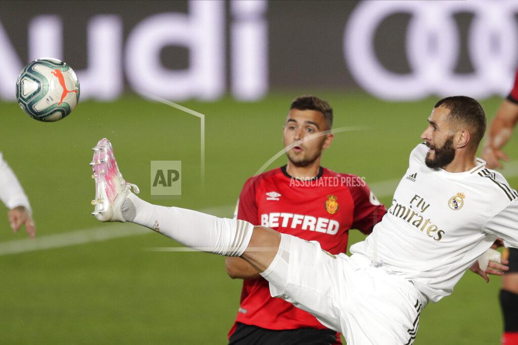 Bernat Armangue Real Madrid's Karim Benzema, right, vies for the ball with Mallorca's Aleksandar Sedlar during the Spanish La Liga soccer match between Real Madrid and Mallorca at Alfredo di Stefano stadium in Madrid, Spain, Wednesday, June 24, 2020. (AP Photo/Bernat Armangue)