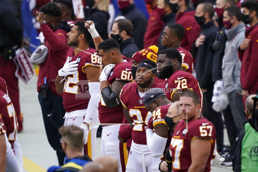 Susan Walsh Members of the Washington Football Team on the sidelines before the start of the first half of an NFL football game against Dallas Cowboys, Sunday, Oct. 25, 2020, in Landover, Md. (AP Photo/Susan Walsh)