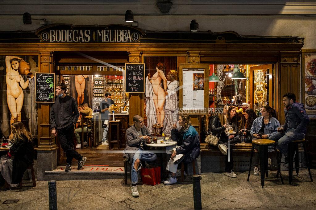 Bernat Armangue Tourists and locals have drinks at a bar in downtown Madrid, Spain, Friday, March 26, 2021. With its policy of open bars and restaurants, Madrid has built itself a reputation of something like Europe's last reduct for fun. That's driving some business to locals and giving politicians and the media much to debate about ahead of a regional election. (AP Photo/Bernat Armangue)