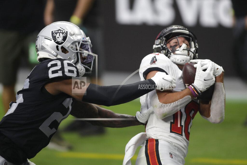 Isaac Brekken Tampa Bay Buccaneers wide receiver Scott Miller (10) catches a pass for a touchdown over Las Vegas Raiders cornerback Nevin Lawson (26) during the first half of an NFL football game, Sunday, Oct. 25, 2020, in Las Vegas. (AP Photo/Isaac Brekken)
