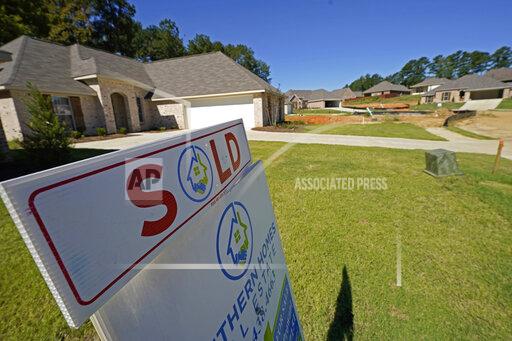 A "Sold" sign is on display on the lawn of a new house in Pearl, Miss., Thursday, Sept. 23, 2021. Fierce competition, low mortgage rates and soaring prices helped drive how much homebuyers borrowed to purchase a home in 2021 to an all-time high, eclipsing the mid-2000s housing boom peak. Banks issued an estimated $1.61 trillion in home purchase loans last year, an increase of about 9% from 2020, according to the Mortgage Bankers Association. (AP Photo/Rogelio V. Solis)