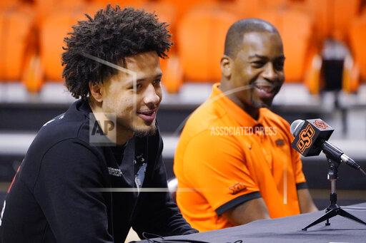 Sue Ogrocki Cade Cunningham, left, and Oklahoma State head coach Mike Boynton Jr., right, announce that Cunningham will enter the NBA draft after a dynamic freshman season that saw him named a first-team AP All-American, Thursday, April 1, 2021, in Stillwater, Okla. (AP Photo/Sue Ogrocki)