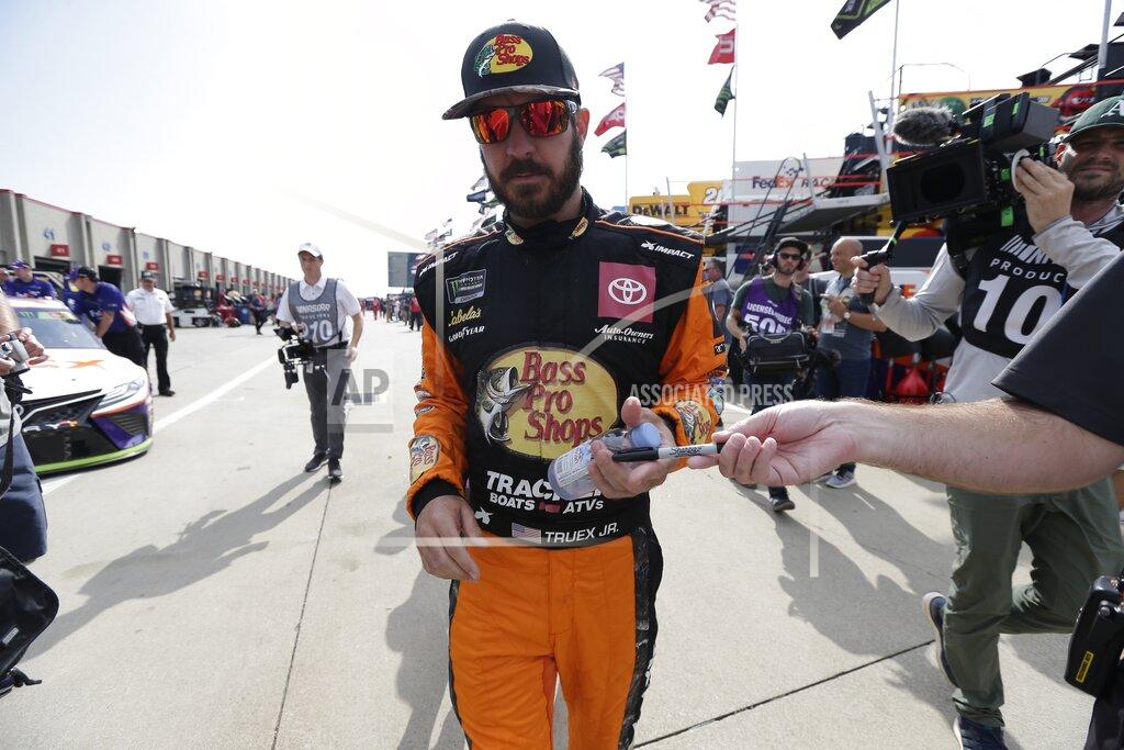 Gerry Broome Martin Truex Jr. signs autographs for fans during practice prior to Sunday's NASCAR Cup Series auto race at Charlotte Motor Speedway in Concord, N.C., Saturday, Sept. 28, 2019. (AP Photo/Gerry Broome)
