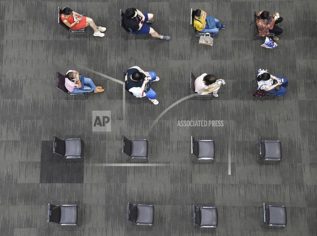 Sakchai Lalit People sit and wait after receiving the AstraZeneca COVID-19 vaccine to be sure of no side effects at Paragon shopping mall in Bangkok, Thailand, Monday, June 7, 2021. Health authorities in Thailand on Monday began their much-anticipated mass rollout of locally produced AstraZeneca vaccine, but it appeared that supplies were falling short of demand from patients who had scheduled vaccinations for this week. (AP Photo/Sakchai Lalit)
