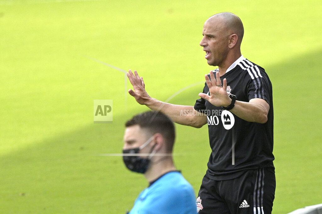 Phelan M. Ebenhack Toronto FC head coach Chris Armas, right, calls out instructions during the first half of an MLS soccer match against the Vancouver Whitecaps, Saturday, April 24, 2021, in Orlando, Fla. (AP Photo/Phelan M. Ebenhack)