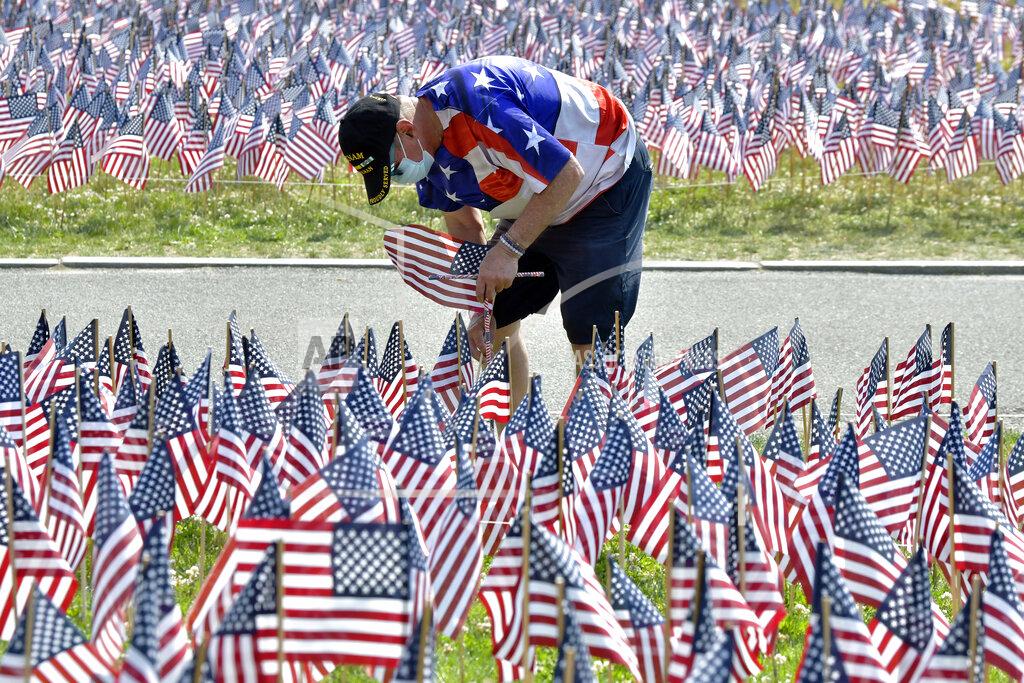 Josh Reynolds Bill Allen, of Winthrop, Mass., who served in the Army in Vietnam during 1971, was one of the volunteers planting American flags on Boston Common Wednesday, May 26, 2021, in Boston. Each year before Memorial Day weekend the Massachusetts Military Heroes Fund places a flag to represent every fallen member of the U.S. military from Massachusetts since the Revolutionary War. (AP Photo/Josh Reynolds)
