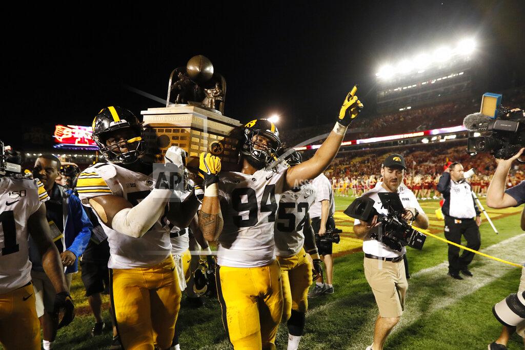Charlie Neibergall Iowa's Chauncey Golston, left, and A.J. Epenesa (94) carry the Cy-Hawk trophy off the field after the team's NCAA college football game against Iowa State, Saturday, Sept. 14, 2019, in Ames, Iowa. Iowa won 18-17. (AP Photo/Charlie Neibergall)