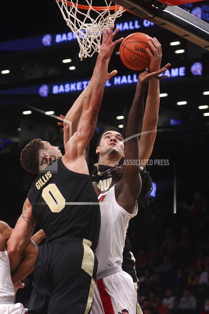 Jason Decrow Purdue's Zach Edey, center, grabs a rebound ahead of teammate Mason Gillis (0) and North Carolina State's Ebenezer Dowuona (21), of Ghana, during the second half of an NCAA college basketball game Sunday, Dec. 12, 2021, in New York. (AP Photo/Jason DeCrow)