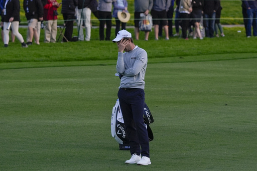 Thomas Detry covers his face after hitting into the water on the 18th hole of the Sorth Course at Torrey Pines during the third round of the Farmers Insurance Open golf tournament, Friday, Jan. 26, 2024, in San Diego. (AP Photo/Gregory Bull)