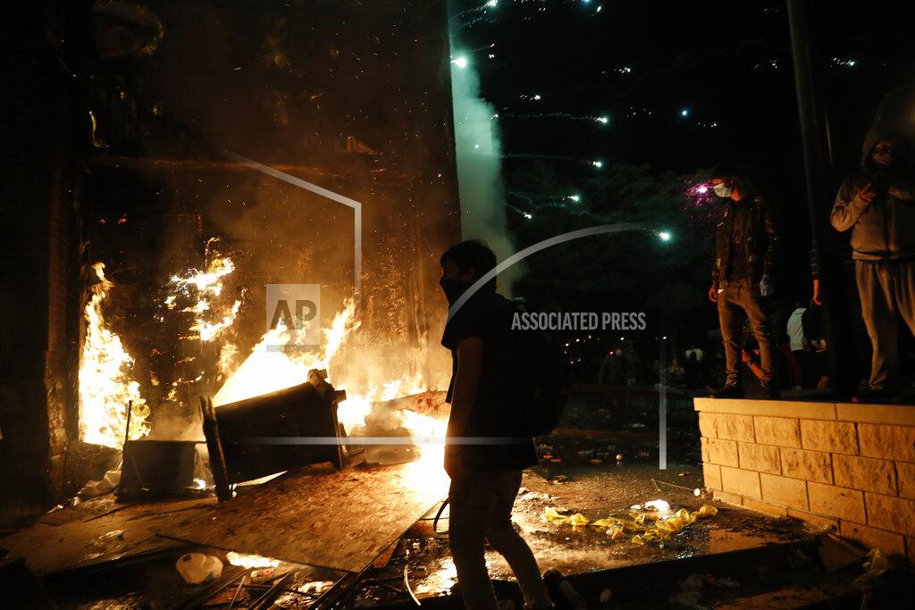 John Minchillo Protesters set fires at the 3rd Precinct of the Minneapolis Police Department, Thursday, May 28, 2020, in Minneapolis. Violent protests over the death of George Floyd, the black man who died in police custody, broke out in Minneapolis for a third straight night. (AP Photo/John Minchillo)