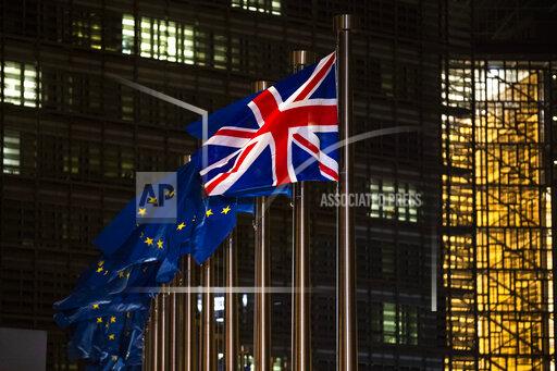 FILE - In this Wednesday, Dec. 9, 2020 file photo,the Union Flag and European Union flags flap in the wind prior a meeting between European Commission President Ursula von der Leyen and British Prime Minister Boris Johnson at EU headquarters in Brussels. Across the English Channel, Brexit supporters in British politics and the media often depict a conniving EU, deeply hurt by the U.K.'s decision to leave, and doing its utmost to make Brexit less than a success by throwing up bureaucratic impediments. (AP Photo/Francisco Seco, File)