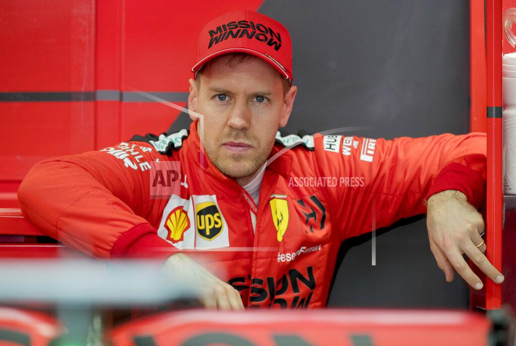 Joan Monfort Scuderia Ferrari Mission Winnow's Sebastian Vettel stands at his box during the Formula One pre-season testing session at the Barcelona Catalunya racetrack in Montmelo, outside Barcelona, Spain, Friday, Feb. 21, 2020. (AP Photo/Joan Monfort)