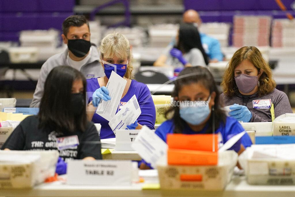 Seth Wenig FILE - In this Oct. 24, 2020 file photo, ballot board workers process mail-in ballots at Bergen Community College in Paramus, N.J. (AP Photo/Seth Wenig, File)