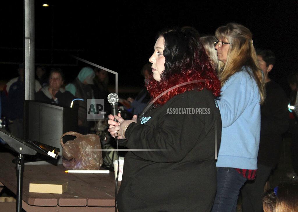 Dean Shalhoup MJ Morrison, an aunt of Elijah Lewis' oldest brother, begins to address the crowd during a candlelight vigil in remembrance of 5-year-old Elijah, at Watson Park in Merrimack, N.H, Sunday, Oct. 24, 2021. Hundreds of people gathered for the candlelight vigil for the young boy from New Hampshire who went missing a month ago and was recently found dead. (Dean Shalhoup/The Telegraph via AP)