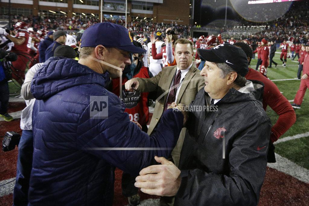 Young Kwak California head coach Justin Wilcox, left, and Washington State head coach Mike Leach speak after an NCAA college football game in Pullman, Wash., Saturday, Nov. 3, 2018. Washington State won 19-13. (AP Photo/Young Kwak)