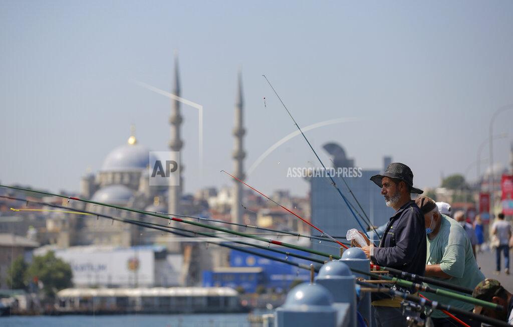 Mucahid Yapici People fish on Galata Bridge with Yeni Cami in the background in Eminonu district in Istanbul, Tuesday, July 27, 2021. Turkey has recorded more than 15,000 new coronavirus cases, as the number of infections continue to surge. (AP Photo/Mucahid Yapici)