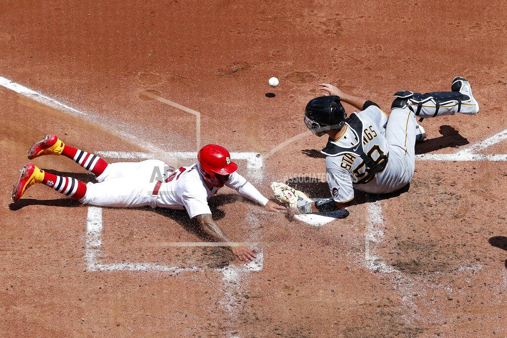 Jeff Roberson St. Louis Cardinals' Kolten Wong, left, scores as Pittsburgh Pirates catcher Jacob Stallings drops the ball during the third inning of a baseball game Sunday, July 26, 2020, in St. Louis. (AP Photo/Jeff Roberson)