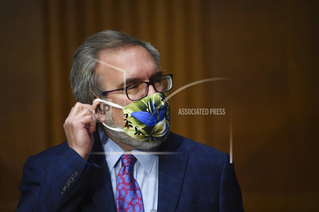 Kevin Dietsch Andrew Wheeler, administrator of the Environmental Protection Agency, adjusts his mask at a hearing during a Senate Environment and Public Works Committee oversight hearing to examine the Environmental Protection Agency, Wednesday, May 20, 2020 on Capitol Hill in Washington. (Kevin Dietsch/Pool via AP)