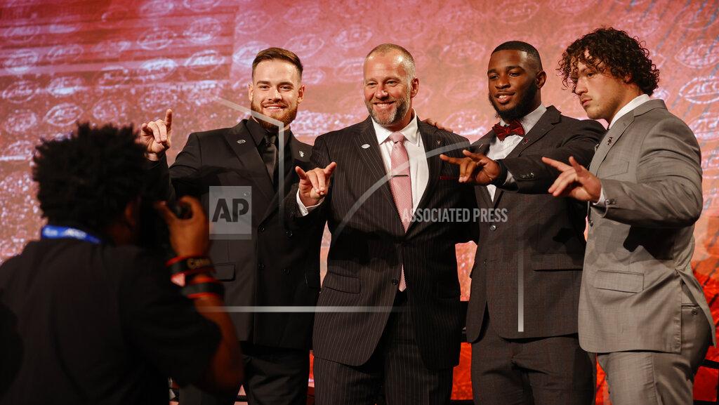 Nell Redmond From left, North Carolina State's Devin Leary, coach Dave Doeren, Isaiah Moore and Drake Thomas pose for a photo onstage at the NCAA college football Atlantic Coast Conference Media Days in Charlotte, N.C., Wednesday, July 20, 2022. (AP Photo/Nell Redmond)