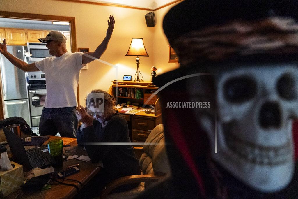 David Goldman Trump supporters Terry, left, and Sherry Frandle talk about at their concerns of what a Biden presidency could bring, in their home in Saint Clair Shores, Mich., Wednesday, Oct. 28, 2020. In Macomb County, Terry hung Trump banners outside his house and noticed that neighbors who used to stop to chat crossed to the other side of the street, not even offering a "hello." Some drivers wave, some flip the bird. He doesn't blame Trump for the discord, he blames Democrats and the media for failing to give Trump a fair shake, he said. He plans to vote in person on Election Day. "I just don't trust anything anymore," he said, except for what he hears directly from Trump. (AP Photo/David Goldman)