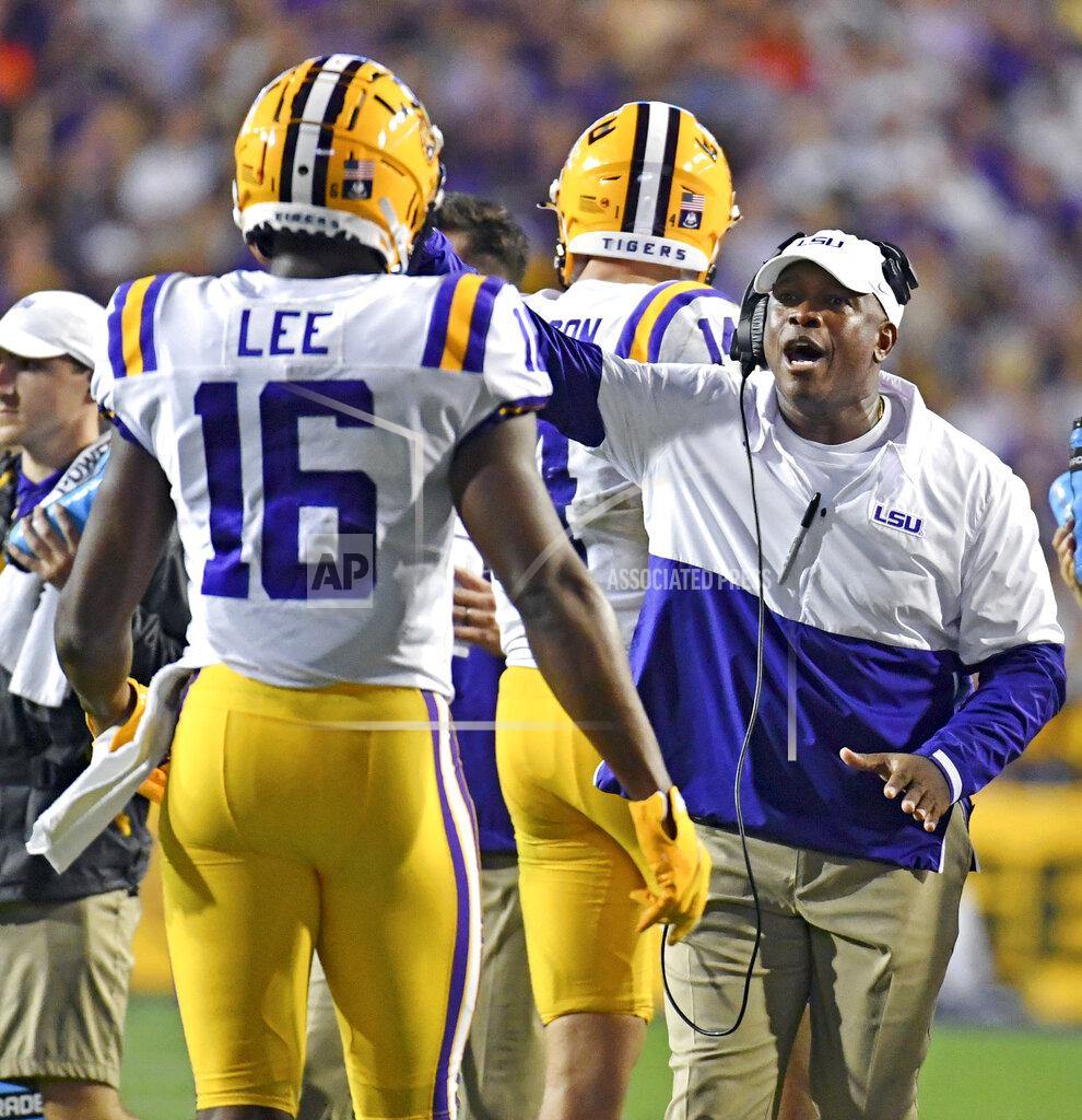 Hilary Scheinuk LSU wide receivers coach Mickey Joseph speaks with wide receiver Devonta Lee (16) during a timeout in the first half of an NCAA college football game against Auburn, on Saturday, Oct. 2, 2021, at Tiger Stadium in Baton Rouge, La. Joseph, who coached wide receivers the last five seasons at LSU, will return to Nebraska as receivers coach, passing game coordinator and associate head coach under Scott Frost. (Hilary Scheinuk/The Advocate via AP)