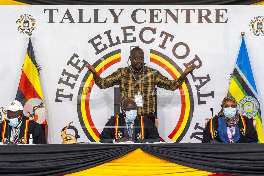Jerome Delay Uganda Electoral Commission chairman Simon Byabakama, seated center, declares Ugandan President Yoweri Kaguta Museveni winner of the presidential elections in Kampala, Uganda, Saturday Jan. 16, 2021. Uganda’s electoral commission says longtime President Yoweri Museveni has won a sixth term, while top opposition challenger Bobi Wine alleges rigging and officials struggle to explain how polling results were compiled amid an internet blackout. In a generational clash widely watched across the African continent, the young singer-turned-lawmaker Wine posed arguably the greatest challenge yet to Museveni. (AP Photo/Jerome Delay)