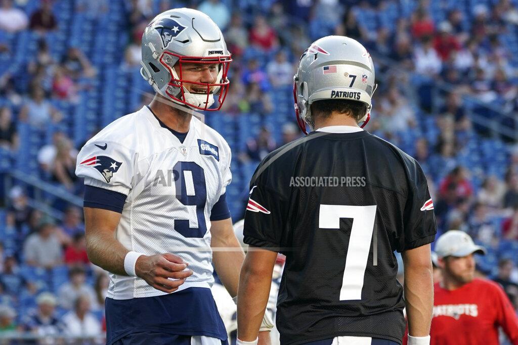Elise Amendola New England Patriots quarterback Jake Dolegala speaks with punter Jake Bailey (7) during NFL football practice Friday, Aug. 6, 2021, in Foxborough, Mass. (AP Photo/Elise Amendola)