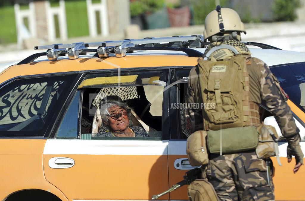 Rahmat Gul The mother of the mosque's imam, Mofti Noman, cries inside a car near the mosque after a bomb explosion in Shakar Dara district of Kabul, Afghanistan, Friday, May 14, 2021. A bomb ripped through a mosque in northern Kabul during Friday prayers killing 12 worshippers, Afghan police said. Noman, was among the dead, a spokesman said and added that the initial police investigation suggests the imam may have been the target. (AP Photo/Rahmat Gul)