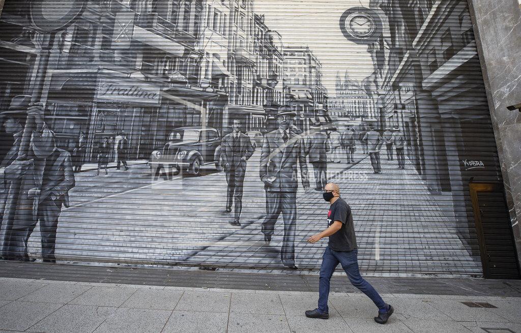 Andre Penner A man walks in front of a shuttered outfit store during a quarantine imposed by the state government to help contain the spread of the new coronavirus in Sao Paulo, Brazil, Monday, June 1, 2020. (AP Photo/Andre Penner)