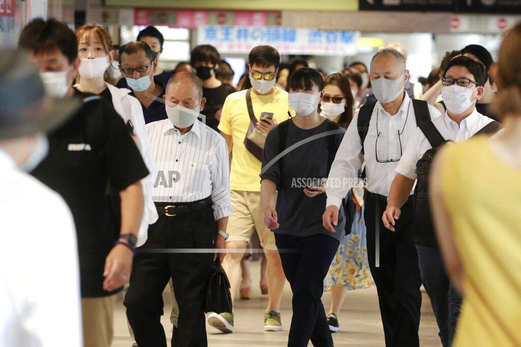 Koji Sasahara People wearing face masks to protect against the spread of the coronavirus walk at a train station in Tokyo Wednesday, July 28, 2021. Tokyo Gov. Yuriko Koike on Wednesday urged younger people to cooperate with measures to bring down the high number of infections and get vaccinated, saying their activities are key to slowing the surge during the Olympics. On Tuesday, the Japanese capital reported 2,848 new cases, exceeding its previous record in January. (AP Photo/Koji Sasahara)