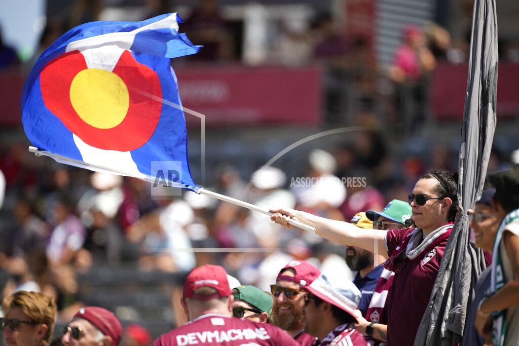 David Zalubowski A fFan waves a Colorado state flag while cheering for the Colorado Rapids in the first half of an MLS soccer match against Los Angeles FC, Saturday, May 14, 2022, in Commerce City, Colo. (AP Photo/David Zalubowski)