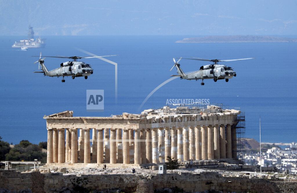 Petros Giannakouris Military helicopters fly over Acropolis Hill during a military parade in Athens, Thursday, March 25, 2021. Greece celebrates the bicentenary of the start of the country's war of independence against the Ottoman Empire. (AP Photo/Petros Giannakouris)
