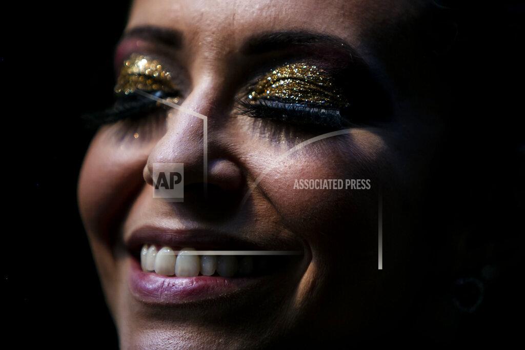 Bruna Prado A member of the "Desliga da Justica" street band gets dressed in her costume in Rio de Janeiro, Brazil, Sunday, Feb. 14, 2021. The group's performance was broadcast live on social media for those who were unable to participate in the carnival due to COVID restrictions after the city's government officially suspended Carnival and banned street parades or clandestine parties. (AP Photo/Bruna Prado)