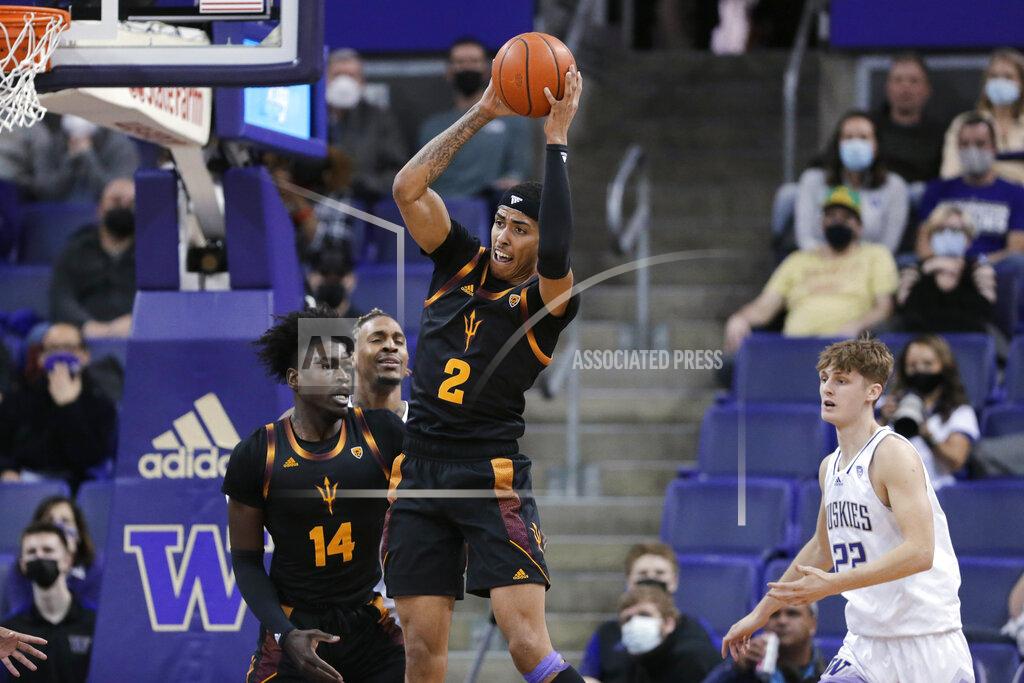 John Froschauer Arizona State's Jalen Graham grabs a rebound next to Enoch Boakye (14) and Washington's Cole Bajema (22) during the first half of an NCAA college basketball game Thursday, Feb. 10, 2022, in Seattle. (AP Photo/John Froschauer)