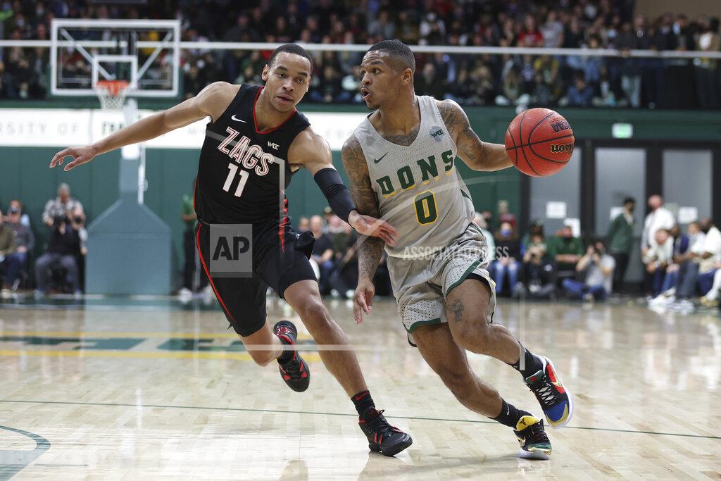 Jed Jacobsohn San Francisco guard Khalil Shabazz (0) drives to the basket against Gonzaga guard Nolan Hickman (11) during the first half of an NCAA college basketball game in San Francisco, Calif., Thursday, Feb. 24, 2022. (AP Photo/Jed Jacobsohn)