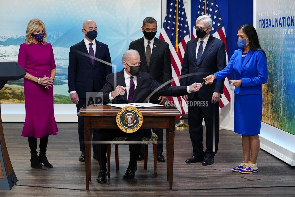 Evan Vucci FILE - President Joe Biden hands a pen to Interior Secretary Deb Haaland after signing an executive order to help improve public safety and justice for Native Americans during a Tribal Nations Summit during Native American Heritage Month, Nov. 15, 2021, in Washington. With the President from left are first lady Jill Biden, Homeland Security Secretary Alejandro Mayorkas, Health and Human Services Secretary Xavier Becerra, Attorney General Merrick Garland and Interior Secretary Deb Haaland. A U.S. Supreme Court ruling expanding state authority to prosecute some crimes on Native American land is upending decades of law in support of tribal sovereignty. (AP Photo/Evan Vucci, File)