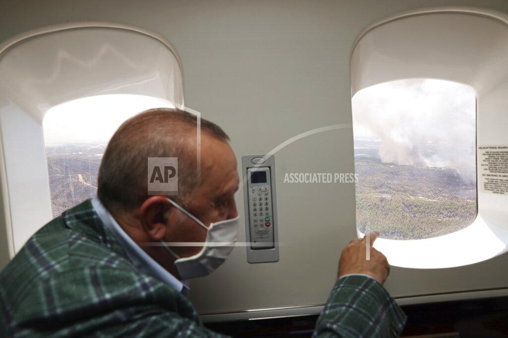 Uncredited Turkey's President Recep Tayyip Erdogan watches from his plane the wildfires in Manavgat, Antalya, Turkey, Saturday, July 31, 2021. The death toll from wildfires raging in Turkey's Mediterranean towns rose to six Saturday after two forest workers were killed, the country's health minister said. Fires across Turkey since Wednesday burned down forests, encroaching on villages and tourist destinations and forcing people to evacuate.(Turkish Presidency via AP, Pool)