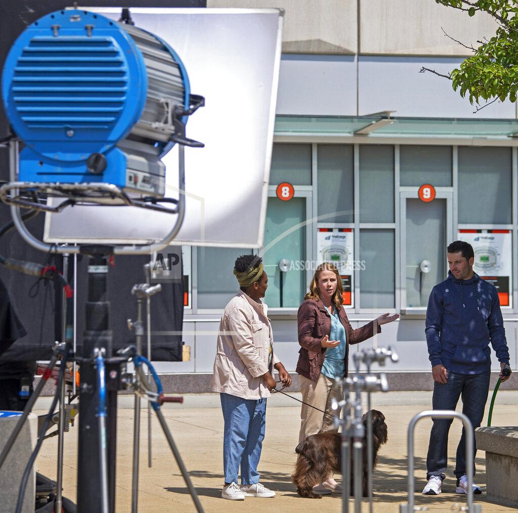 David Dermer Cleveland Browns quarterback Baker Mayfield, right, performs with actors during a Progressive Insurance commercial shoot at FirstEnergy Stadium, Thursday, July 22, 2021, in Cleveland. (AP Photo/David Dermer)