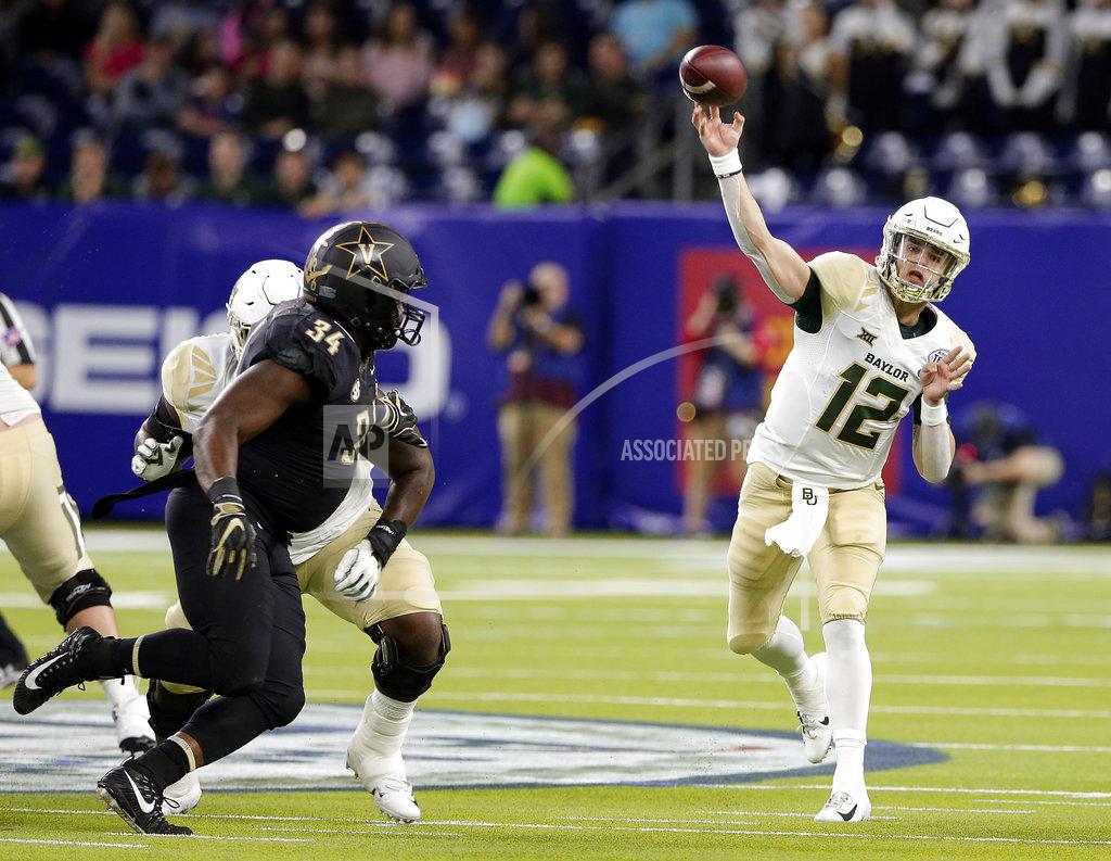 Michael Wyke Baylor quarterback Charlie Brewer (12) passes the ball as Vanderbilt defensive lineman Dare Odeyingbo (34) closes in during the first half of the Texas Bowl NCAA college football game, Thursday, Dec. 27, 2018, in Houston. (AP Photo/Michael Wyke)