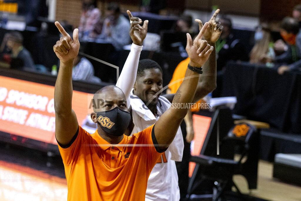 Mitch Alcala Oklahoma State head coach Mike Boynton Jr., front, and Ferron Flavors Jr. celebrate at the end of an NCAA college basketball game against Oakland in Stillwater, Okla., Saturday, Dec. 5, 2020. (AP Photo/Mitch Alcala)