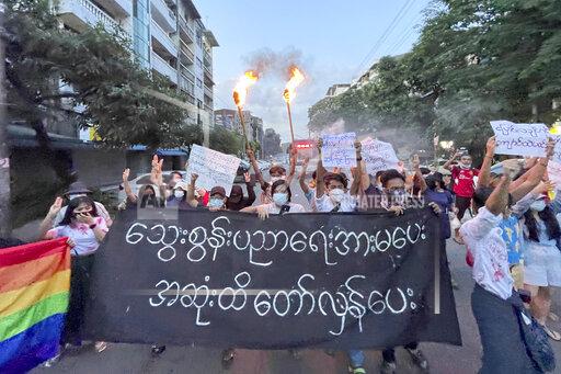 A small group of protesters hold a banner which reads in Burmese 'Do not support the bloody education, revolt until the end' while calling for a boycott of the education system under the military government that ousted Myanmar leader Aung San Suu Kyi, during a flash mob rally in Tarmwe township in Yangon, Myanmar, Wednesday, Nov. 10, 2021. (AP Photo)
