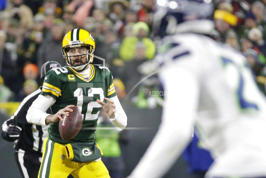Mike Roemer Green Bay Packers' Aaron Rodgers drops back during the first half of an NFL divisional playoff football game against the Seattle Seahawks Sunday, Jan. 12, 2020, in Green Bay, Wis. (AP Photo/Mike Roemer)