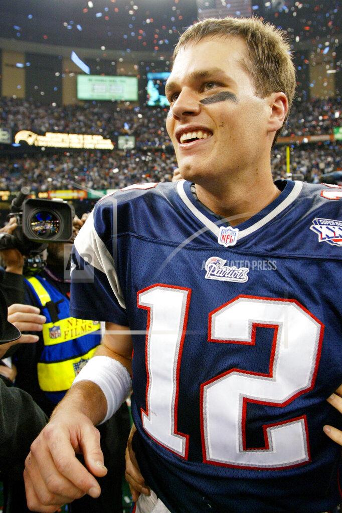 Doug Mills FILE - In this Feb. 3, 2002, file photo, New England Patriots quarterback Tom Brady smiles after the Patriots defeated the St. Louis Rams 20-17 in NFL football's Super Bowl XXXVI in New Orleans. A pair of Super Bowl winning teams that launched dynasties in San Francisco and New England highlighted the list of the NFL's greatest teams, numbers 31-100. The Patriots won a surprise title in 2001 after the untested Brady took over from the injured Drew Bledsoe early in the season. New England needed a favorable ruling and dramatic kick by Adam Vinatieri to win the "Tuck Rule" game against Oakland, won at Pittsburgh in the AFC championship game and slowed down the dynamic Rams offense for the franchise's first title. That team ranked 51st. (AP Photo/Doug Mills, File)